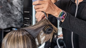 a client getting her hair blowdry