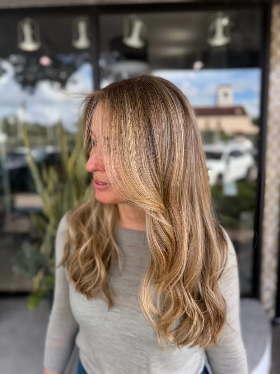 Honey blonde balayage side view at MG Hair Studios